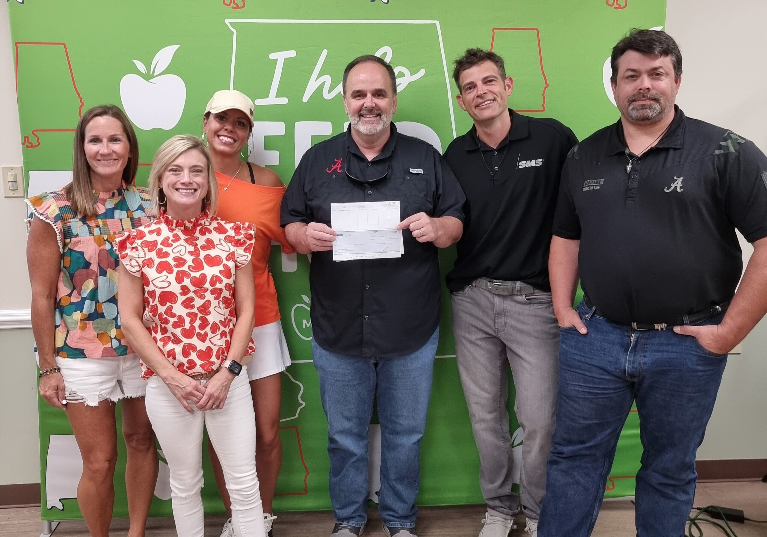 Aaron Graffius and Robert Nicholson of SMS presenting the check to Michael Coleman, MAFB CEO